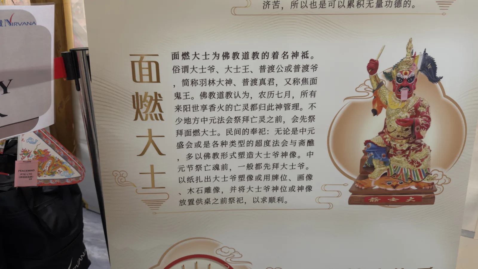 Information board at the Nirvana Zhong Yuan ceremony describing 面燃大士 Mian Ran Da Shi, with a painted figure of the deity holding a flag