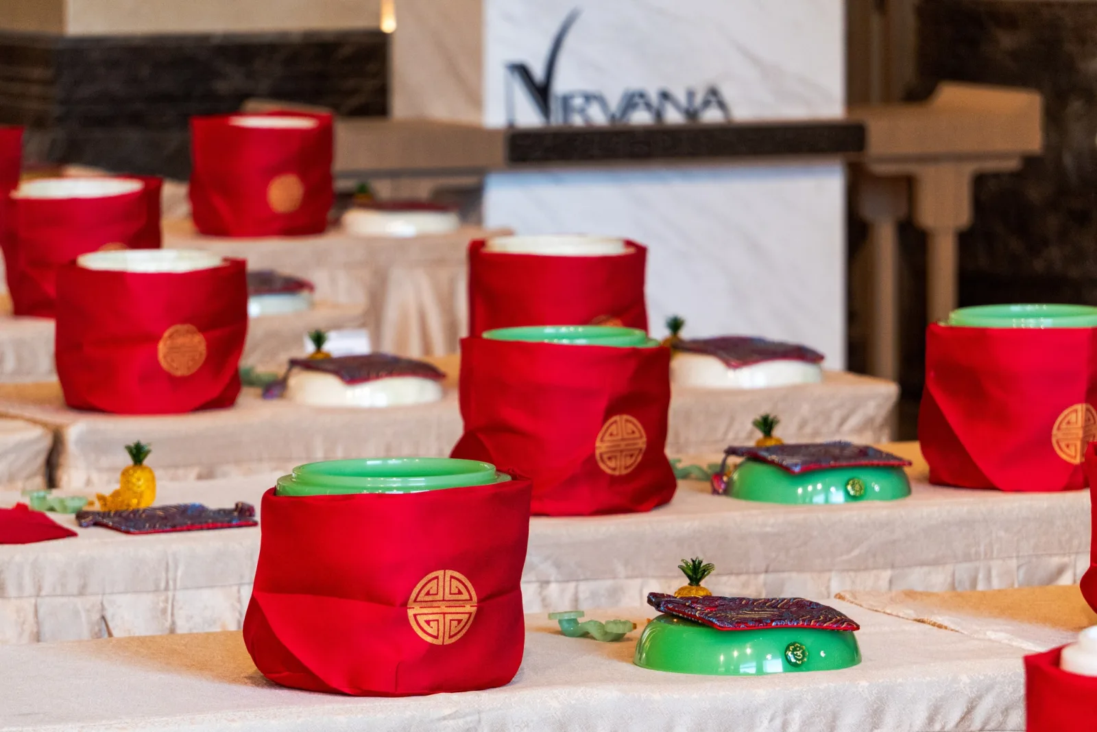 Jade cremation urns wrapped in red cloth displayed at the ceremony
